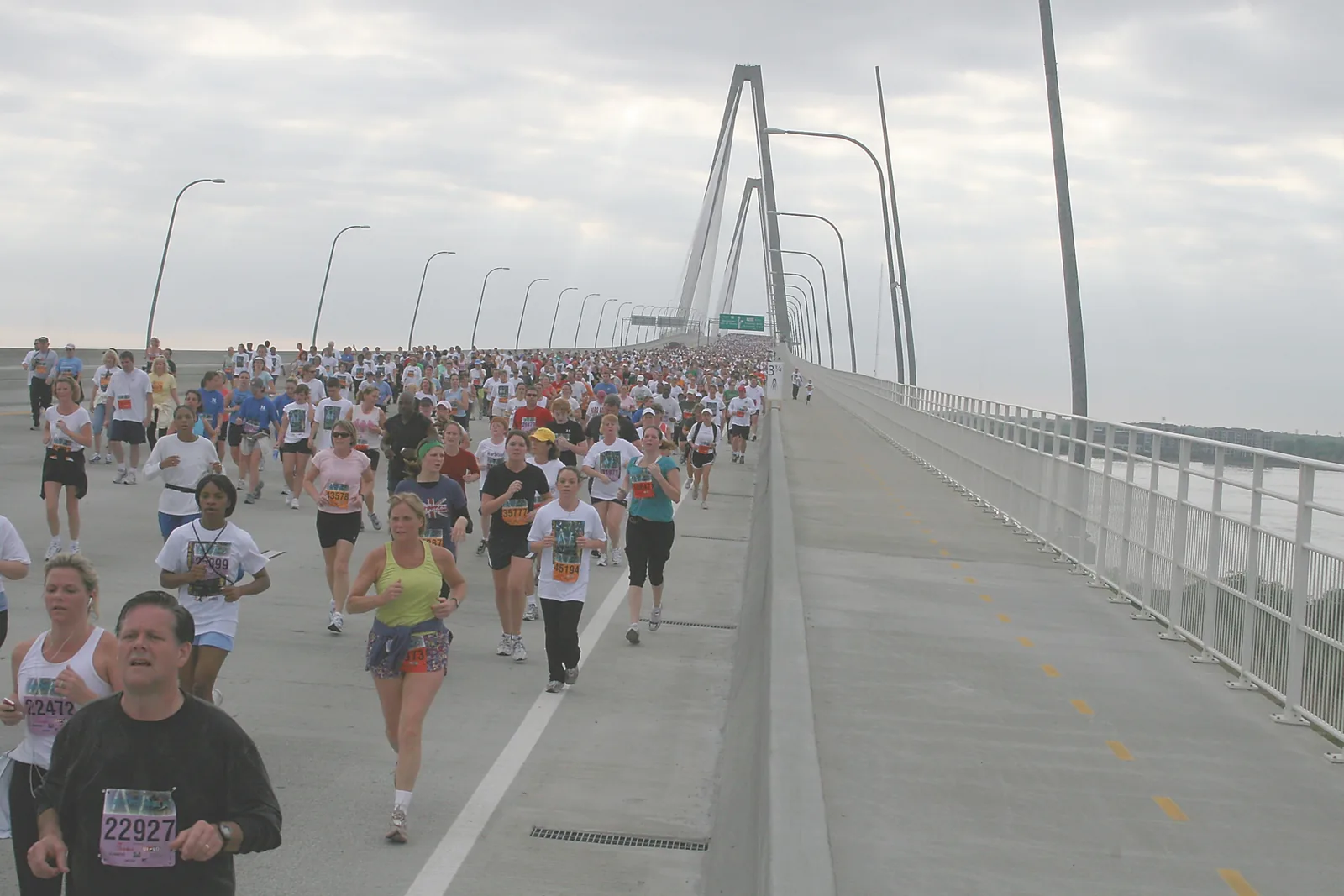 Runners and walkers cross the Arthur Ravenel Jr. Bridge from Mount Pleasant toward Charleston during the Cooper River Bridge Run.