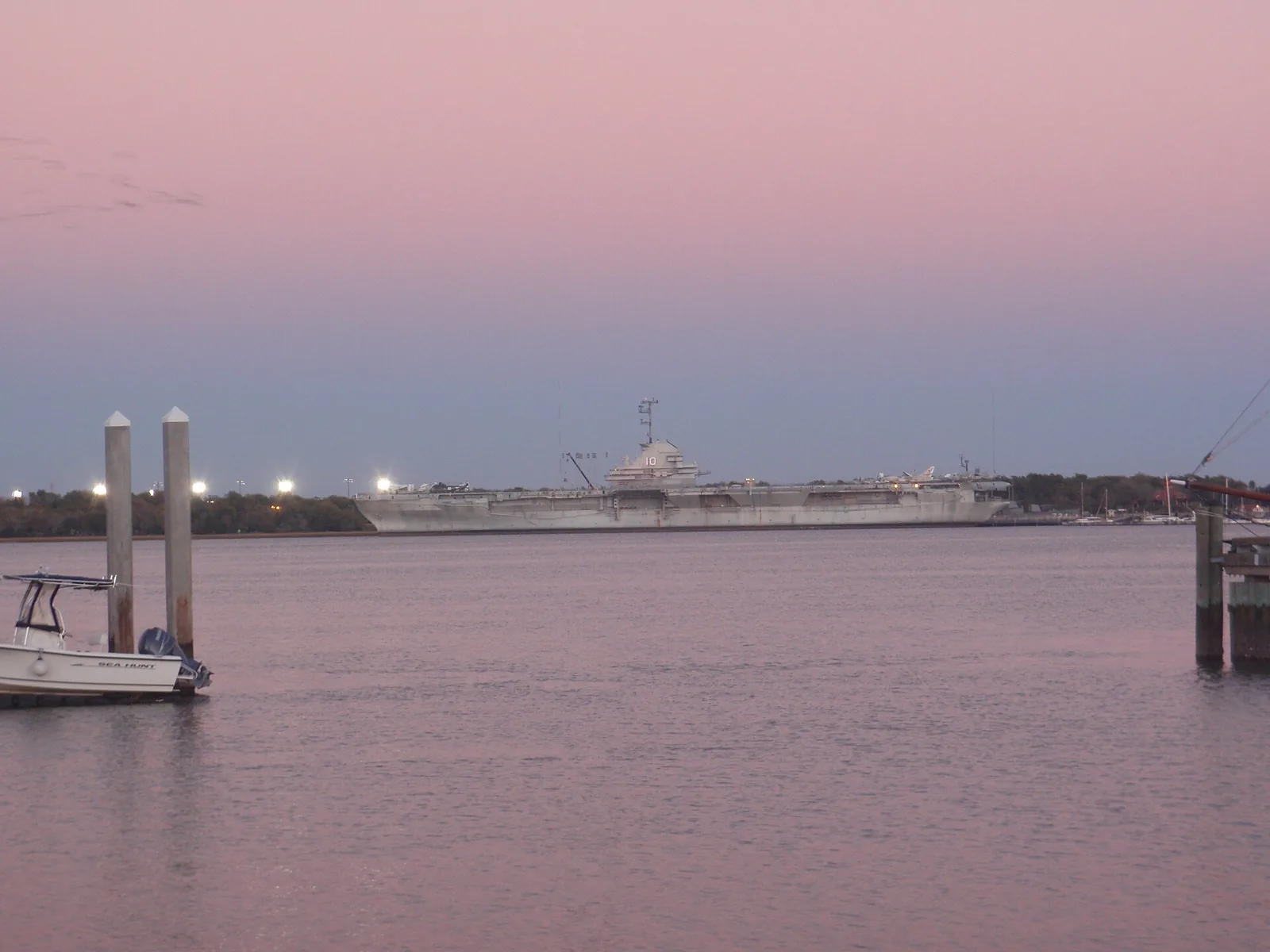 The aircraft carrier USS Yorktown at Patriots Point at dusk, seen across Charleston Harbor.