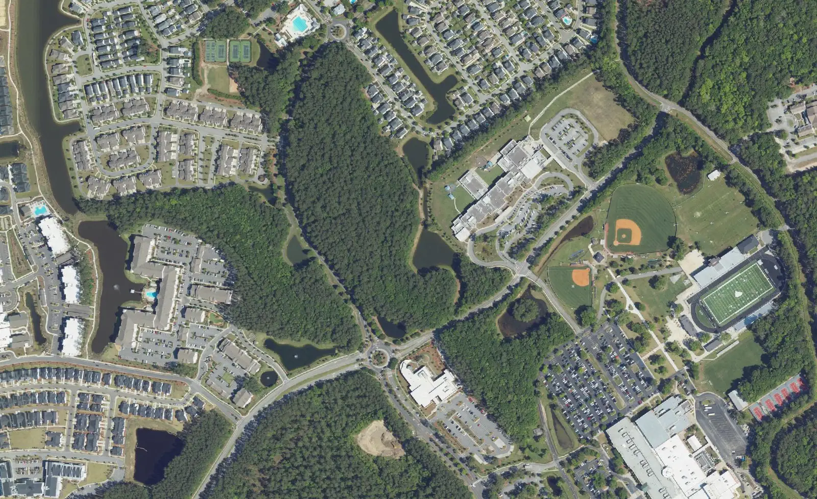 Aerial view of Carolina Park in Mount Pleasant, with homes, lakes, woods and school sports fields.