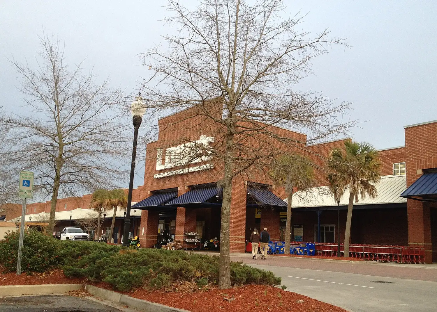 Shoppers outside the brick storefront of the Lowe's home improvement store in Mount Pleasant.