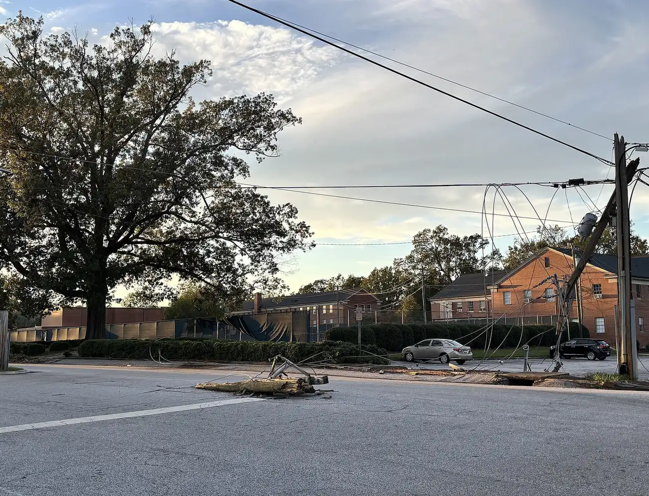 A snapped utility pole and downed power lines lie across an intersection in Clinton, South Carolina, after Hurricane Helene.