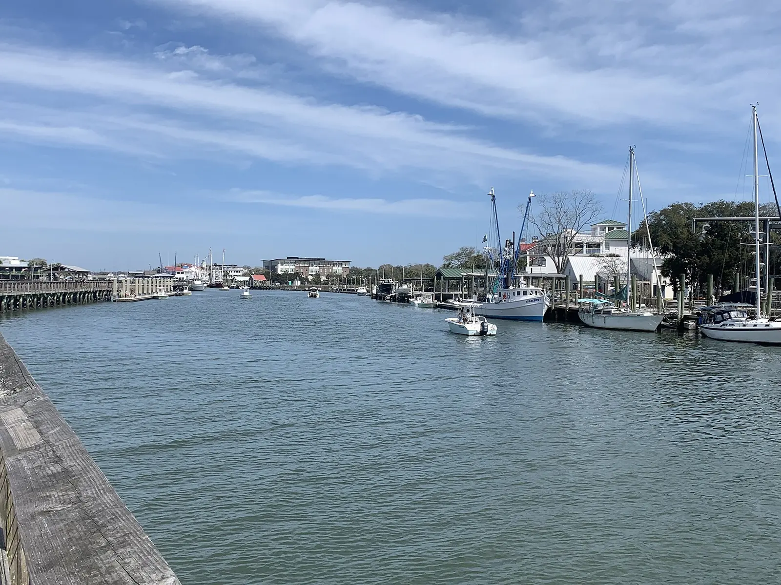 Shem Creek in Mount Pleasant, looking down the creek past the boardwalk and docked boats.