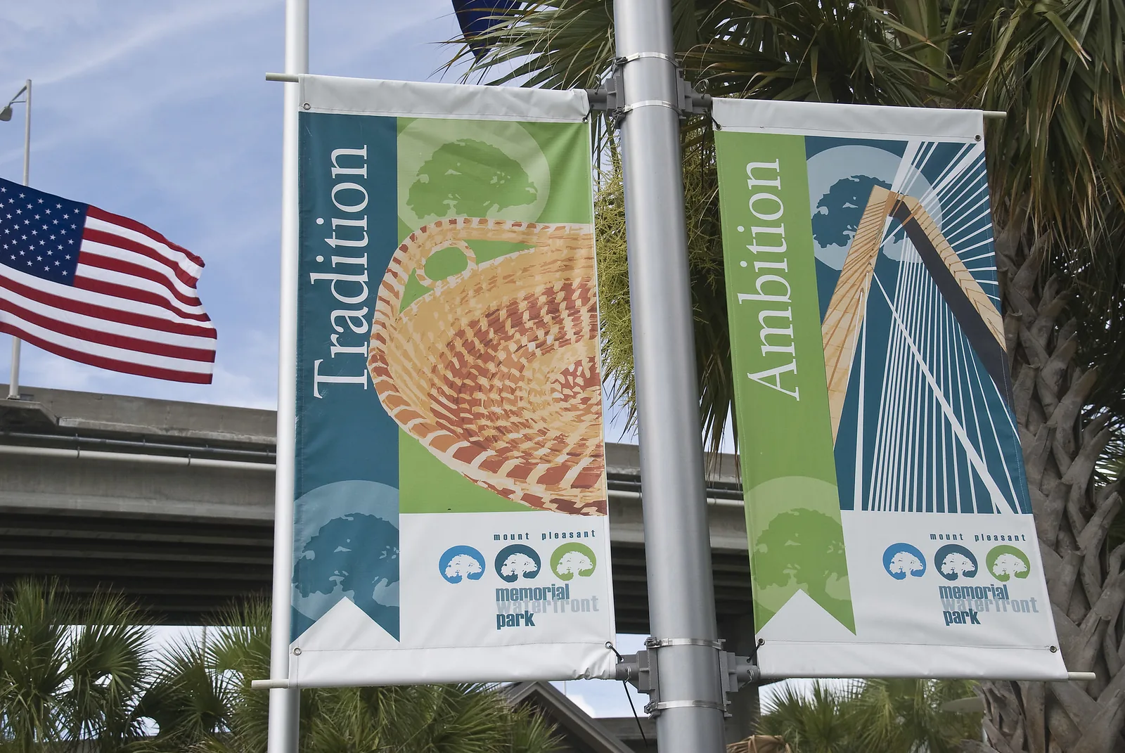 A banner at Memorial Waterfront Park in Mount Pleasant shows a sweetgrass basket beside the word Tradition.