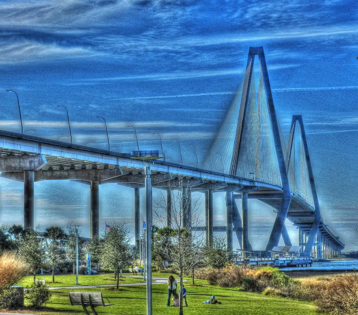 Memorial Waterfront Park in Mount Pleasant, with the Ravenel Bridge and the Mount Pleasant Pier beyond the lawn.