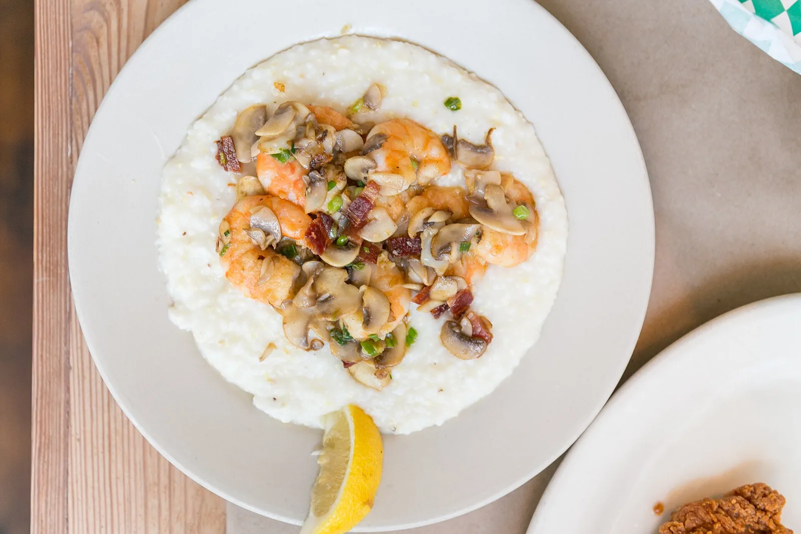 Shrimp and grits with mushrooms, scallions and bacon, a Lowcountry plate served at many restaurants. The photo was not taken in Mount Pleasant.