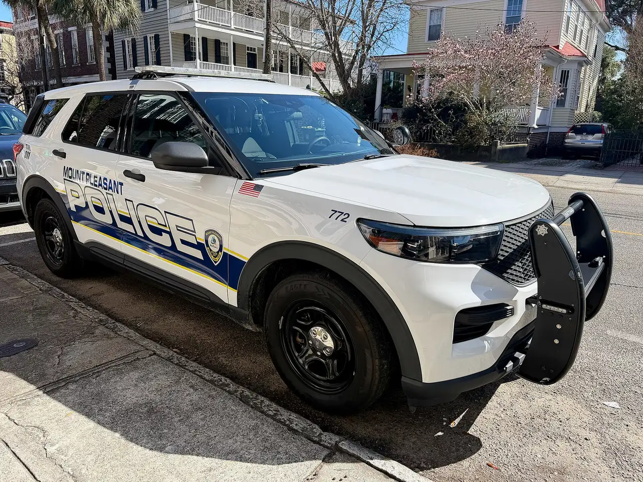 A Mount Pleasant Police Department SUV parked at the curb on a residential street.